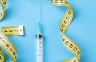 Close-up of a medical injection being administered by a healthcare professional.